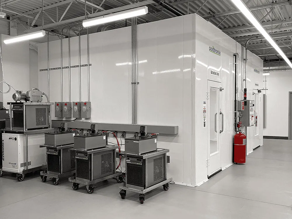 Multi-zone double-wall installation with external recirculating chillers, vacuum pumps, and fire-suppression cylinders staged outside the classified envelope.