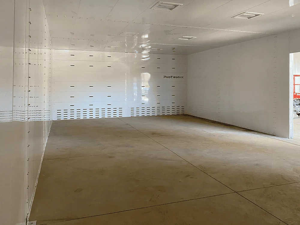 Empty multi-zone interior — first-class clean-room finish with full-height perforated airflow wall, ready for tenant equipment fit-out.