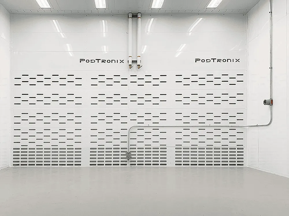 Branded perforated exhaust plenum wall delivering uniform airflow across the enclosure for safe vapor purging during normal and alarm operation.