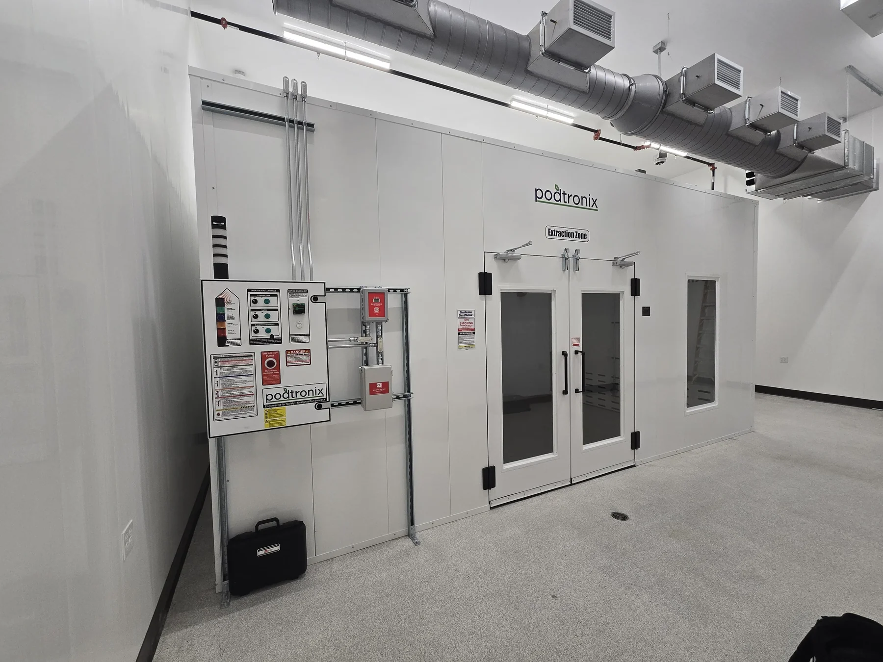 Extraction room entrance with exterior controls and overhead ductwork