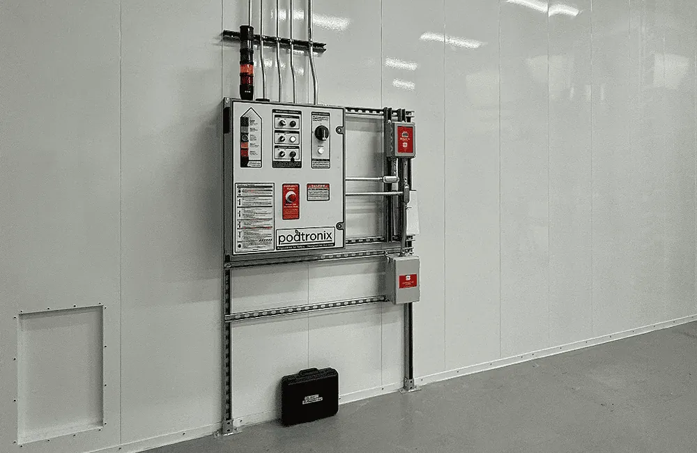 Exterior Podtronix control panel – VFD, E-stop, status alarm tower, and circuit breaker assembly