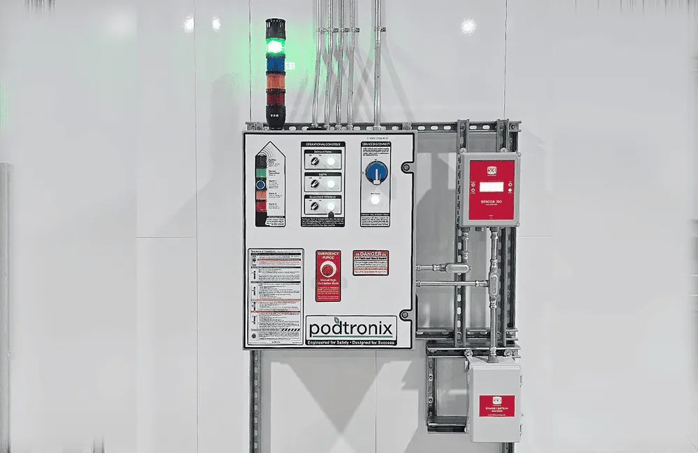 Podtronix control panel close-up – exhaust fan, lighting, equipment interlock, emergency purge, gas detection (RKI Beacon 900), and service disconnect
