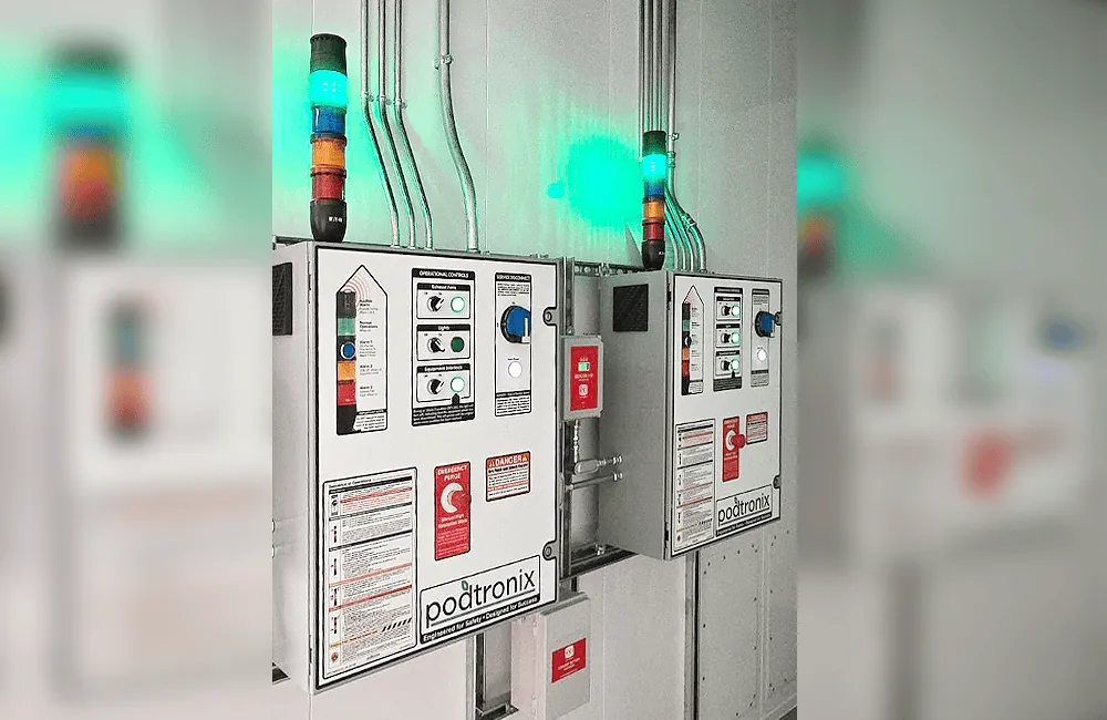 Dual Podtronix control panels with status alarm towers illuminated green – system operational